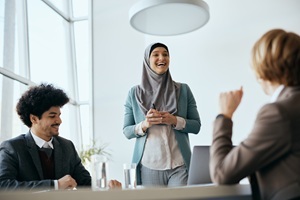 happy-muslim-business-leader-talking-to-her-cowork-2024-12-13-20-08-35-utc